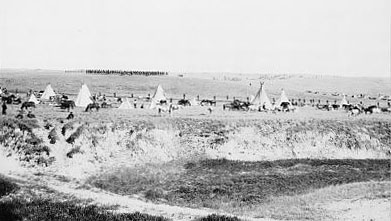 Photo: Reenactment of U.S. troops surrounding the Lakota at Wounded Knee (1913).